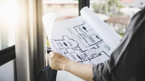 Architectural building design and construction plans with blueprints, Young m Stock Photos