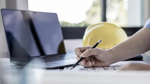 Architectural building design and construction plans with blueprints, Young m Stock Photos