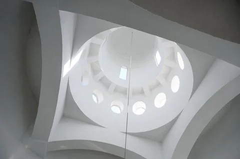 Architectural ceiling design with circular skylights and white walls Stock Photos