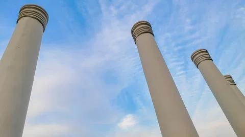 An architectural close-up of pillars touching  the blue sky. Touching the sky Foto stock