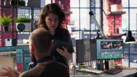 Architectural design team configures a floor plan on dual monitors Stock Footage 308674474