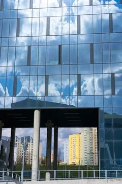 Architectural detail of the facade with multiple reflections of cloudy sky an Stock Photos