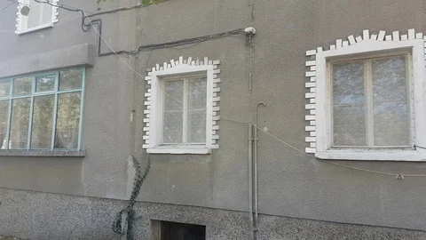 Architectural detail: white window frames on grey wall Vídeos de archivo 104764348