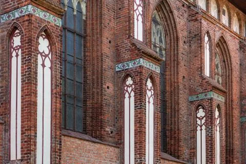 Architectural elements, vaults and windows of gothic cathedral. Red Brick wal Stock Photos