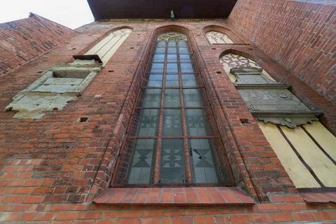 Architectural elements, vaults and windows of gothic cathedral. Red Brick wal Stock Photos