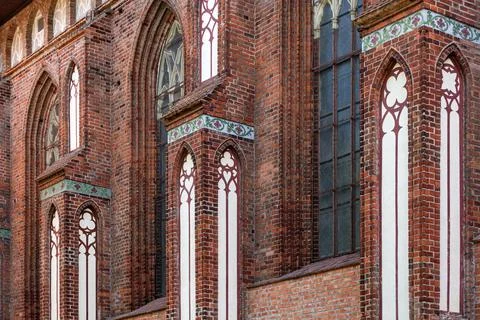 Architectural elements, vaults and windows of gothic cathedral. Red Brick wal Stock Photos