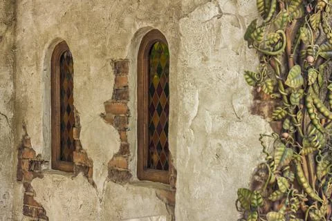 Architectural elements of the wall, windows with colored stained glass. An ol Stock Photos