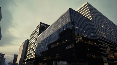 Architectural focus on glass towers with dramatic sunset background Stock Footage 329172142