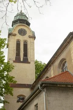 Architectural heritage scene with clock faces and natural framing Stock Photos