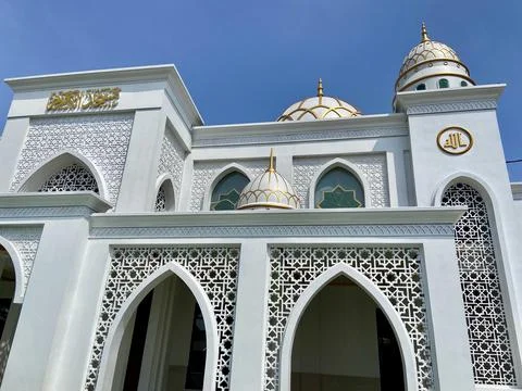 Architectural Low Angle View of White Mosque with Golden Accents and Blue Sky Stock Photos