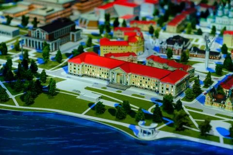 Architectural model of a cityscape featuring buildings, trees, and water el.. Stock Photos