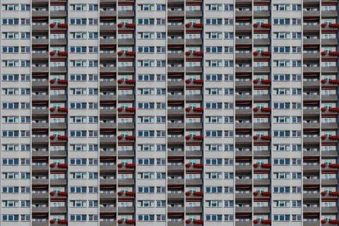 Architectural pattern, facade of a skyscraper with balconies and flower box Stock Photos