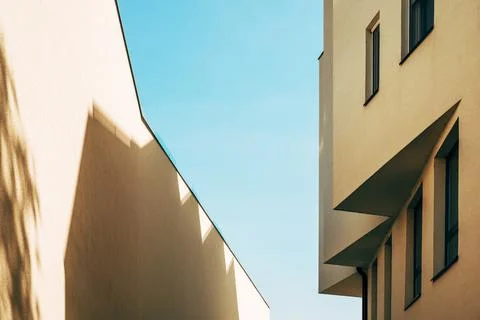 Architectural pattern, modern residential building facade with shadow and l.. Stock Photos