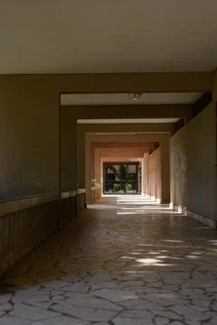 Architectural perspective view of a long covered concrete corridor with rec.. Stock Photos