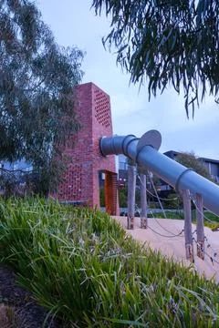Architectural play space featuring a brick climbing tower and slide represe.. Stock Photos