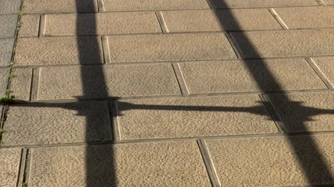 Architectural Railing Shadow Pattern Cast on Sunlit Ground Stock Footage 330245172