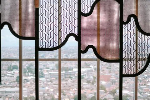 Architectural screen with geometric patterns overlooks a cityscape vista Stock Photos
