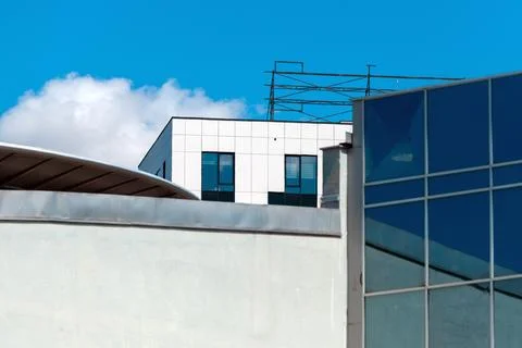 Architectural shot of a contemporary building complex featuring a white til.. Stock Photos