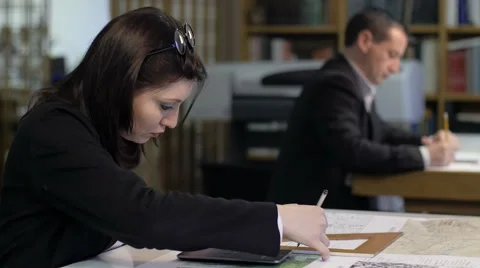 Architectural studio: people working on blueprints and maps Stock-Footage 49790619