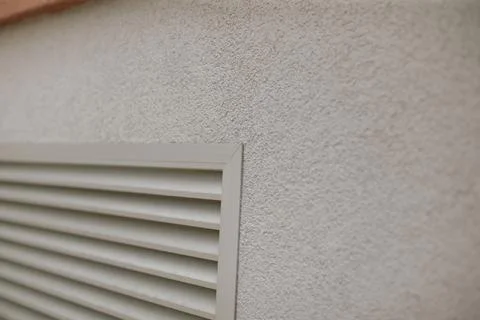 Architectural surface featuring horizontal louvered vent details Stock Photos
