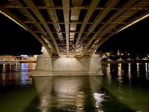 Architectural View Beneath an Illuminated Bridge over the Danube Stock Photos