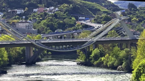 Architectural View of Curved Bridge Over River Stock Footage 276332996