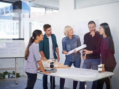 Architecture, blueprint and model with developer team in office together for Stock Photos