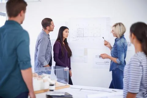 Architecture, coaching and blueprint with developer team in office together for Foto stock