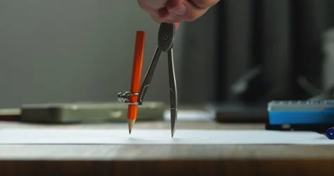Architecture designer draws a circle with a compass, professional engineer Stock Footage 236928287
