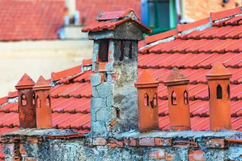 Architecture details of the house with old chimneys and tile roof on the ba.. Stock Photos