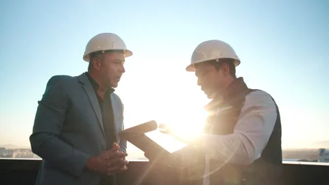 Architecture, discussion and tablet with men on rooftop for city planning or Stock Footage 337923906