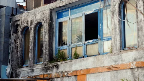 Architecture of Greece. Broken window in building is an old abandoned hotel. 4K Stock Footage 114710045