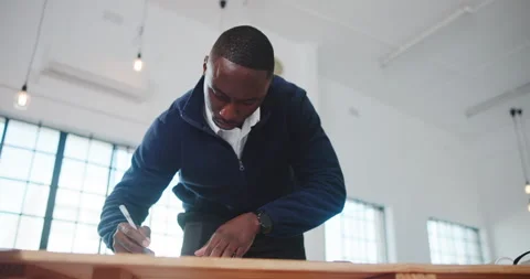 Architecture, office and black man at desk for writing, drawing and blueprint Stock Footage 341591216