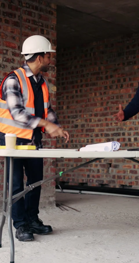 Architecture, people and handshake at construction site with blueprint drawing Stock Footage 336260356
