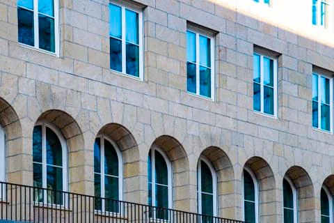 Architecture with rectangular and oval windows on a brick house Stock Photos