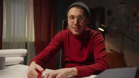 Architecture student is using video conference, showing his drawings. Young Stock Footage 150564136