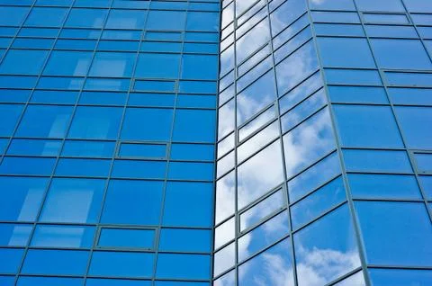 Architecture.surface of glass building with the reflection of clouds Stock Photos
