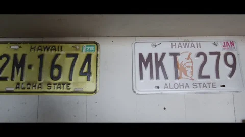 Archive Shot: 4K Old Coke Bottles and Hawaiian License Plates on Wall Stock Footage 72719780