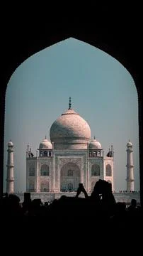 Archway frames the distant view of a modern building in Taj Mahal, Agra Stock Photos