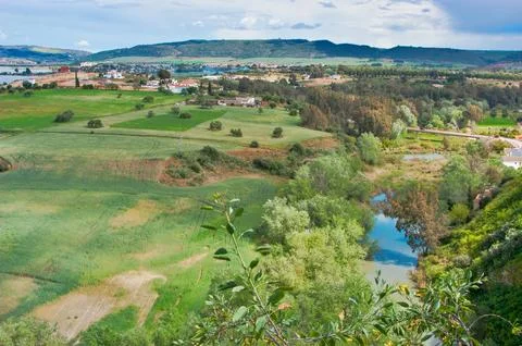 Arcos de La Frontera panorama, river flowing through green fields Stock Photos