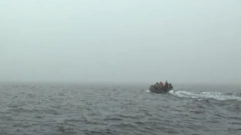 Arctic Adventurers Navigate Ocean Waves Through a Frosty Mist Video stock 344603550