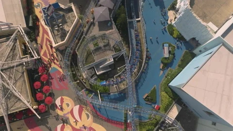 Arctic Express roller coaster hurtles down the track as visitors roam Stock Footage 229694228