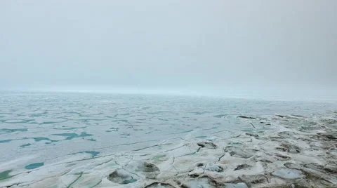 Arctic Landscape Over Ice Covered Water Blue and Green Water Showing Through Ice Stock Footage 56655700
