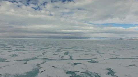 Arctic Landscape Quick Pull Out Over Ice Covered Water, Blue Grey Sky Stock Footage 56660262