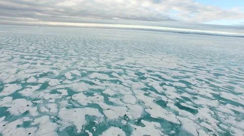 Arctic Landscape Slow Pull Back Across Snow Covered Blue Water Grey Blue  Sky Stock Footage 56655612