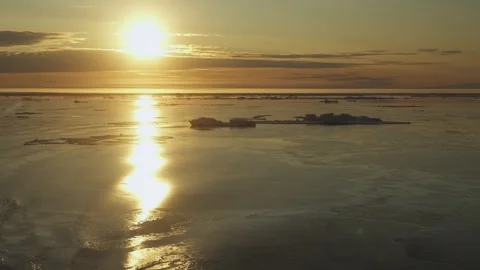 Arctic landscape with sun. View from moving ship. Sunset. Ice is drifting on Stock Footage 266521458