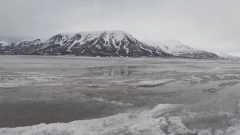 Arctic Meltwater Stream Flowing Through Snow Covered Tundra in Svalbard 스톡 동영상 339277387