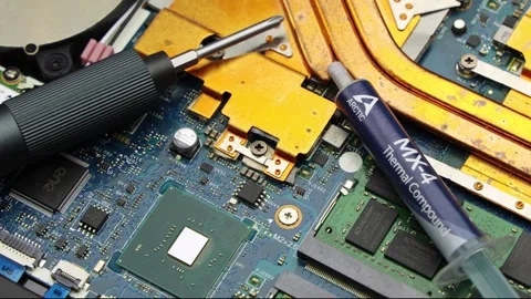 Arctic MX-4 Paste And Screwdriver On Notebook Circuitry Stock Footage 345961611