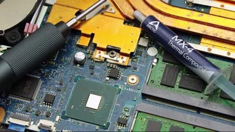 Arctic MX-4 Thermal Paste Tube And Screwdriver On Laptop Board Stock Footage 345961610