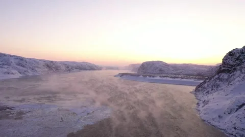 Arctic ocean moving through snowy mountains at sunset 스톡 동영상 288206714